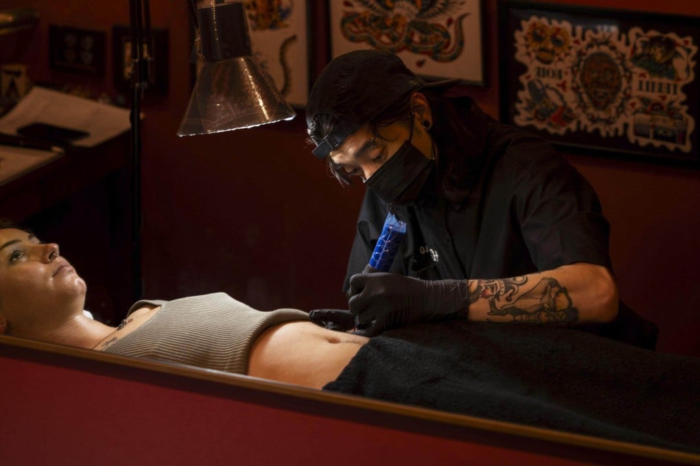 Tattoo artist Horisho works on a foreign tourist at Good Times Ink tattoo studio in Osaka. Photo: Kyodo