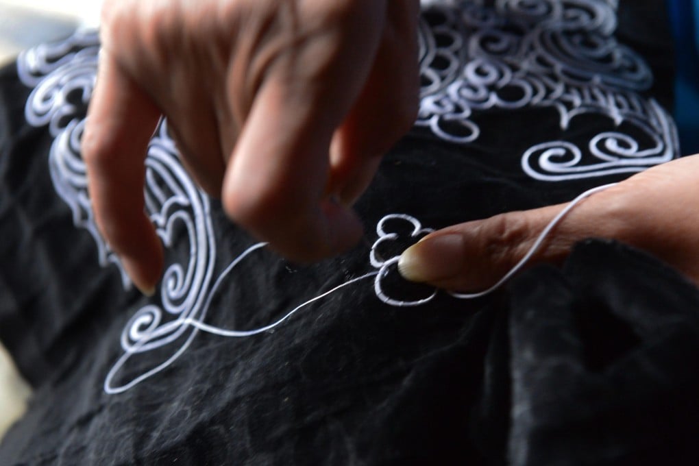 A Shui minority woman embroiders with horsetail in Sandu Shui Autonomous County in China’s Guizhou province. Shui minority women can spend months or even years making a piece of horsetail embroidery, which is used as decoration on clothes, shoes, wallets and more. Photo: Visual China Group via Getty Images