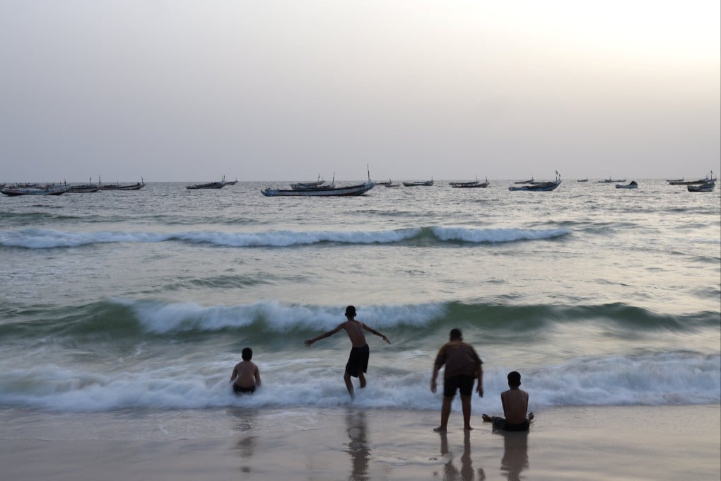 Young people enjoy the waves on a beach near the Nouakchott Artisanal Port in Mauritania on July 17 last year. The UN projects that the world population will grow to 11.2 billion by 2100. Photo: Reuters