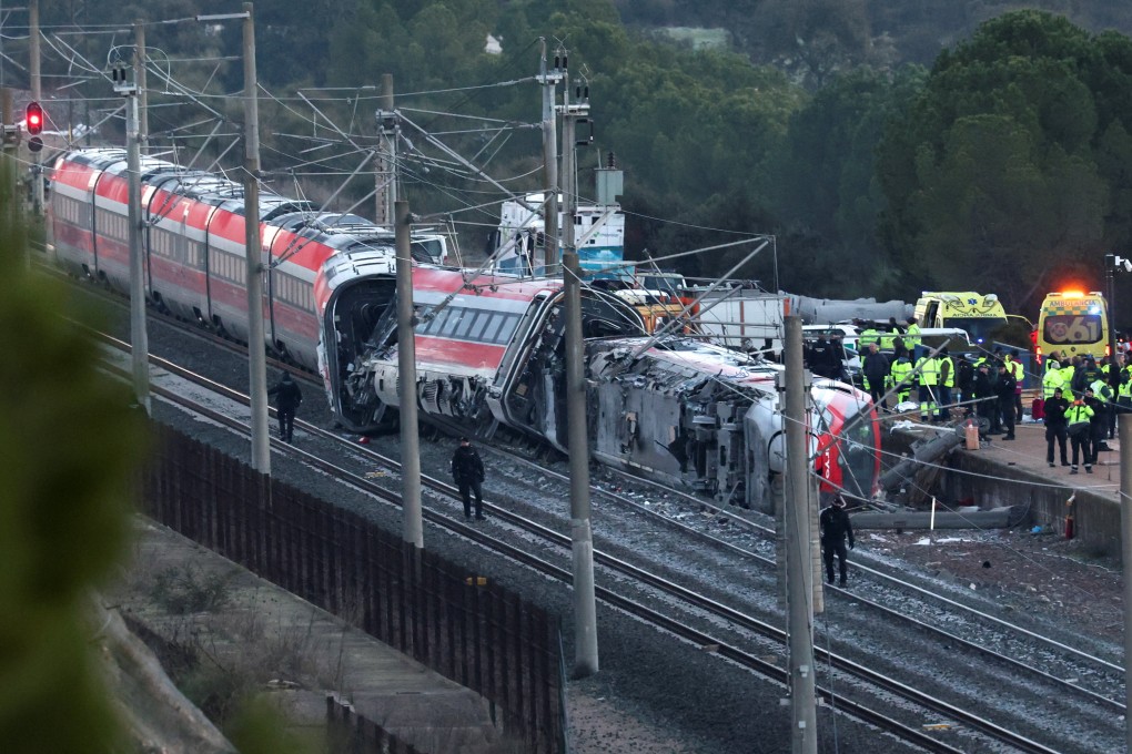 Members of the Spanish Civil Guard, along with other emergency personnel, work next to one of the trains involved in the crash. Photo: Reuters