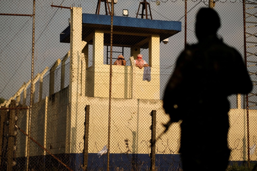 Inmates gather at a watch tower a Renovacion 1 prison as riots erupt in three Guatemalan prisons, with hostages taken, authorities said on Saturday. Photo: Reuters