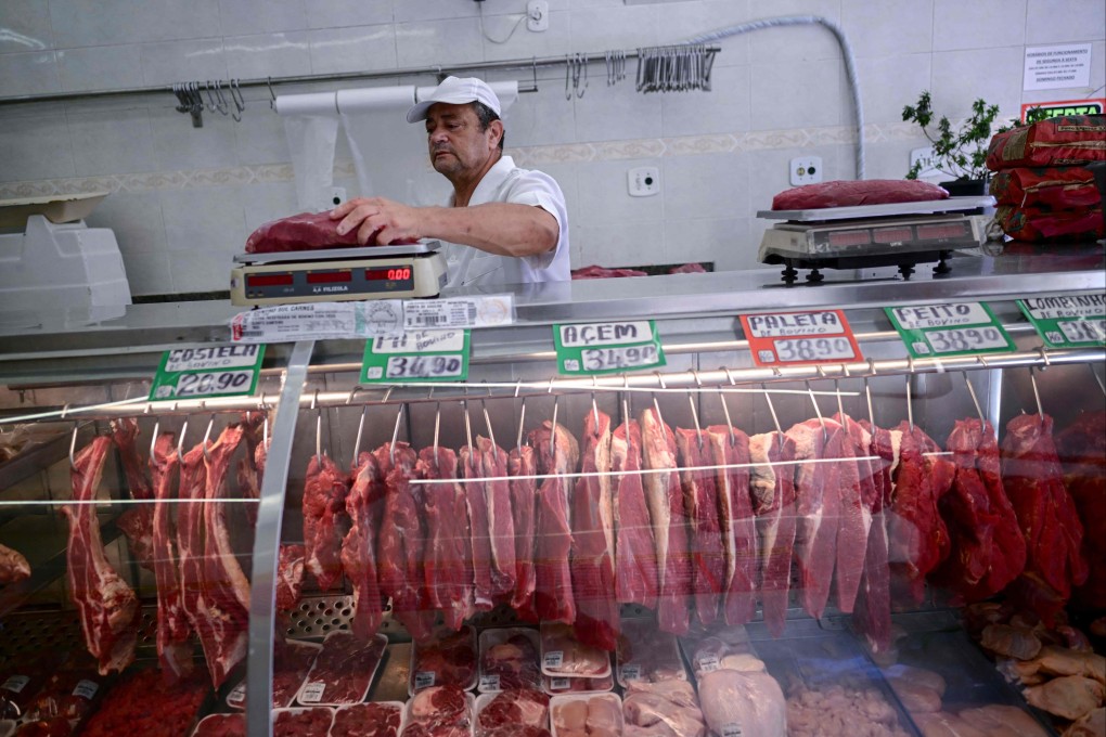 A butcher weighs meat at a butcher shop in Rio de Janeiro, Brazil in 2024. Photo: AFP