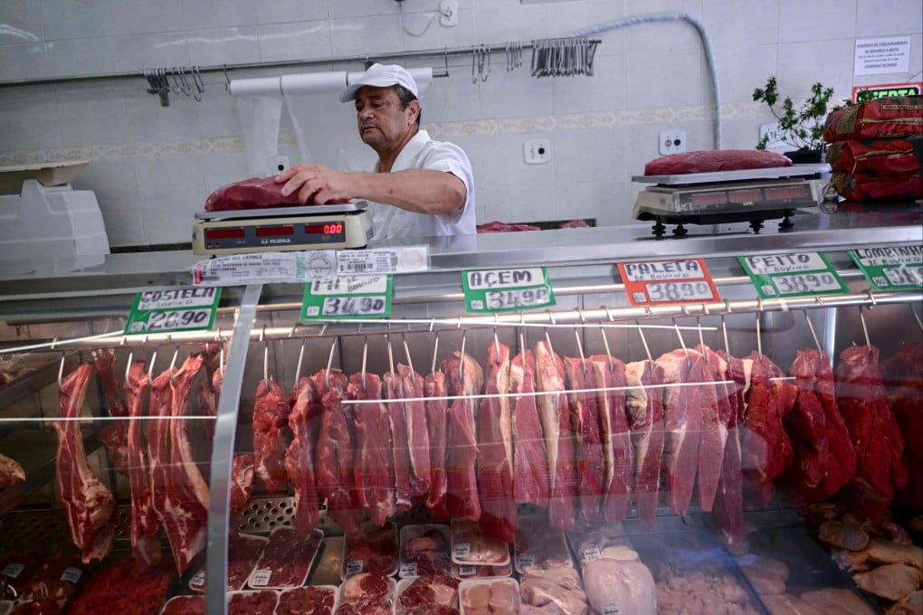 A butcher weighs meat at a butcher shop in Rio de Janeiro, Brazil in 2024. Photo: AFP