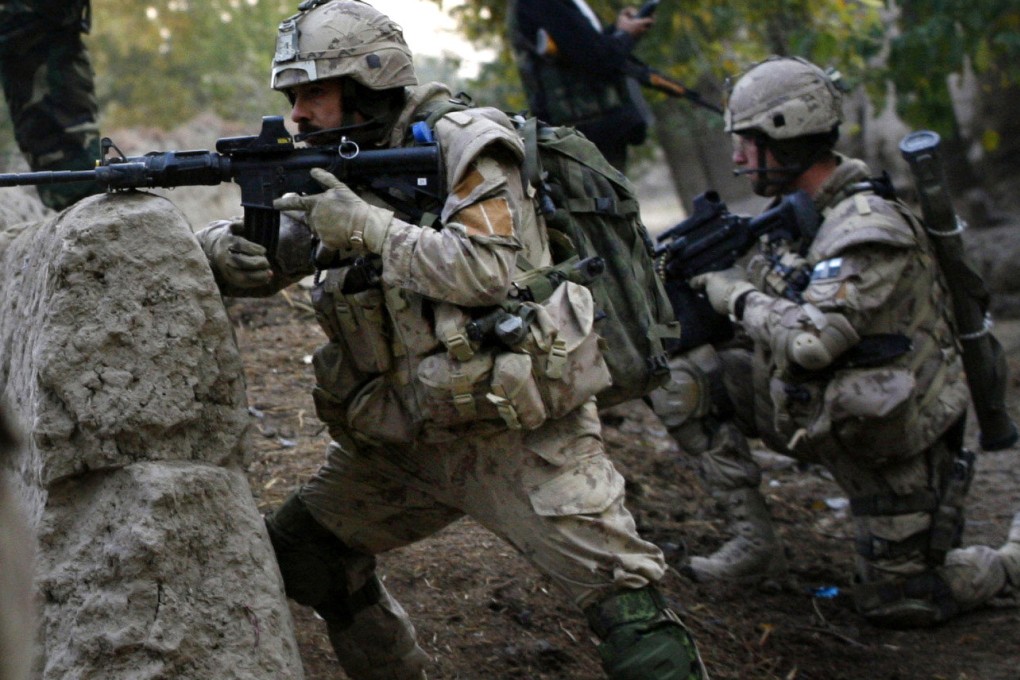 Canadian soldiers and Afghan National Army members take positions during a joint operation to seek out Taliban fighters in Kandahar province in 2006. Photo: AP