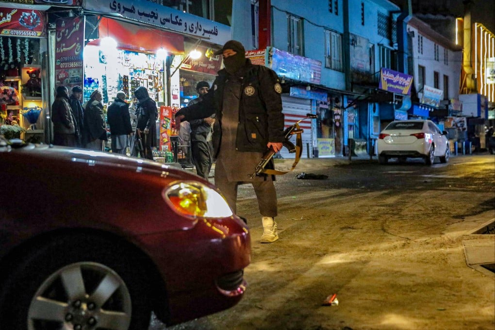 Taliban security personnel stand guard at the scene of the attack in Kabul. Photo: AFP