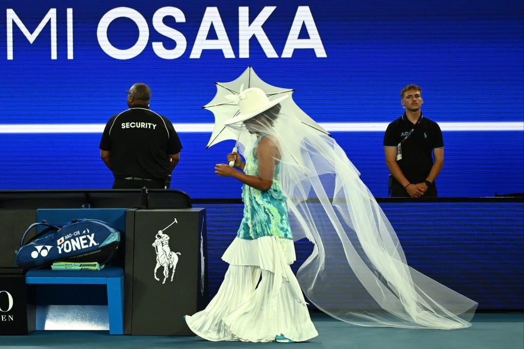 Former world number one Naomi Osaka emerged at Rod Laver Arena clutching a white parasol and wearing a matching wide-brimmed hat and veil. Photo: dpa