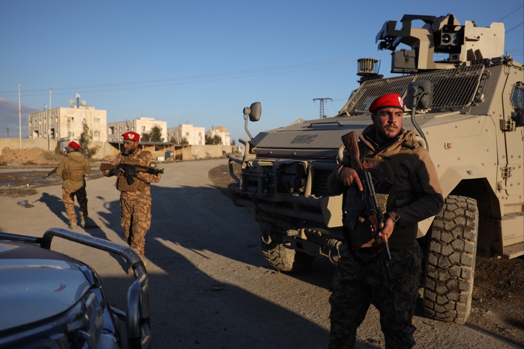 Syrian government forces stand guard outside al-Aqtan prison on the outskirts of Raqqa. Photo: AP