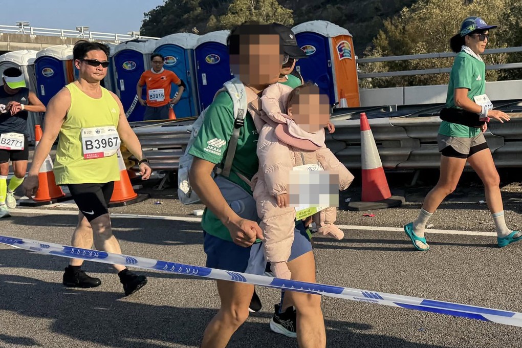 A participant in the 2026 Standard Chartered Hong Kong Marathon last Sunday sparked online discussion after being spotted carrying a baby while running, raising serious safety concerns. Photo: handout