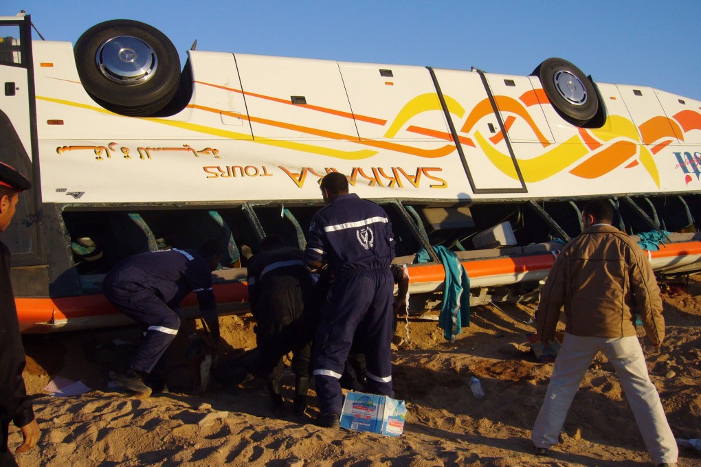 Emergency responders look for survivors inside a toppled bus carrying Hong Kong tourists on January 31, 2006. File photo: Handout