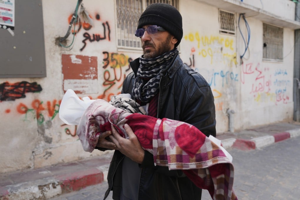 Khalid Abu Jarad holds the body of his 3-month-old niece, Shaza Abu Jarad, who health officials say died on Tuesday from hypothermia. Photo: AP