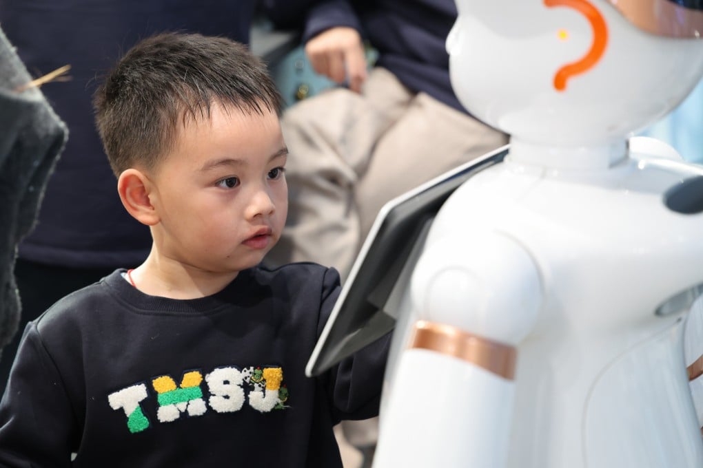 A child interacts with a robot at a store in Shenzhen, in south China’s Guangdong province, on January 16, 2026. Photo: Xinhua