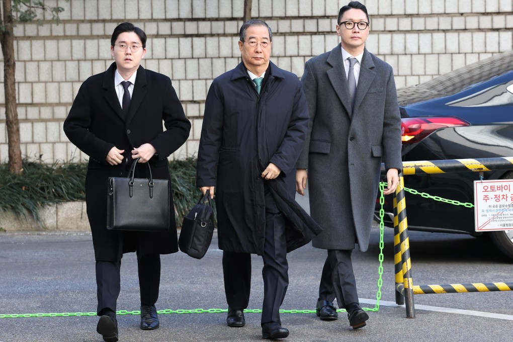 Former South Korean prime minister Han Duck-soo (centre) arrives at the Seoul Central District Court for his sentencing trial in the insurrection case on Wednesday. Photo: AP