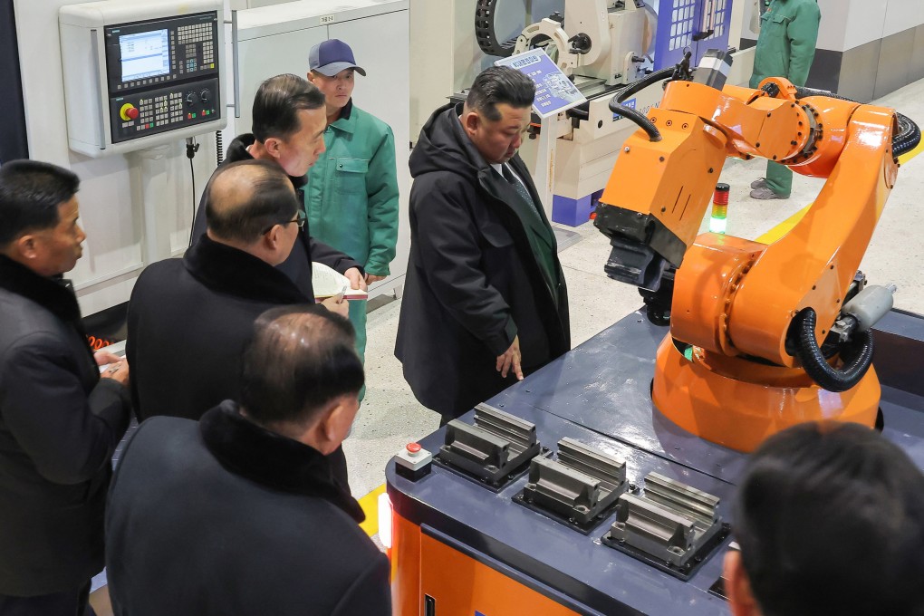 North Korean leader Kim Jong-un  looks at a robot during a  ceremony to mark the completion of the first phase of Ryongsong Machine Complex’s modernisation on Monday. Photo: KCNA/dpa