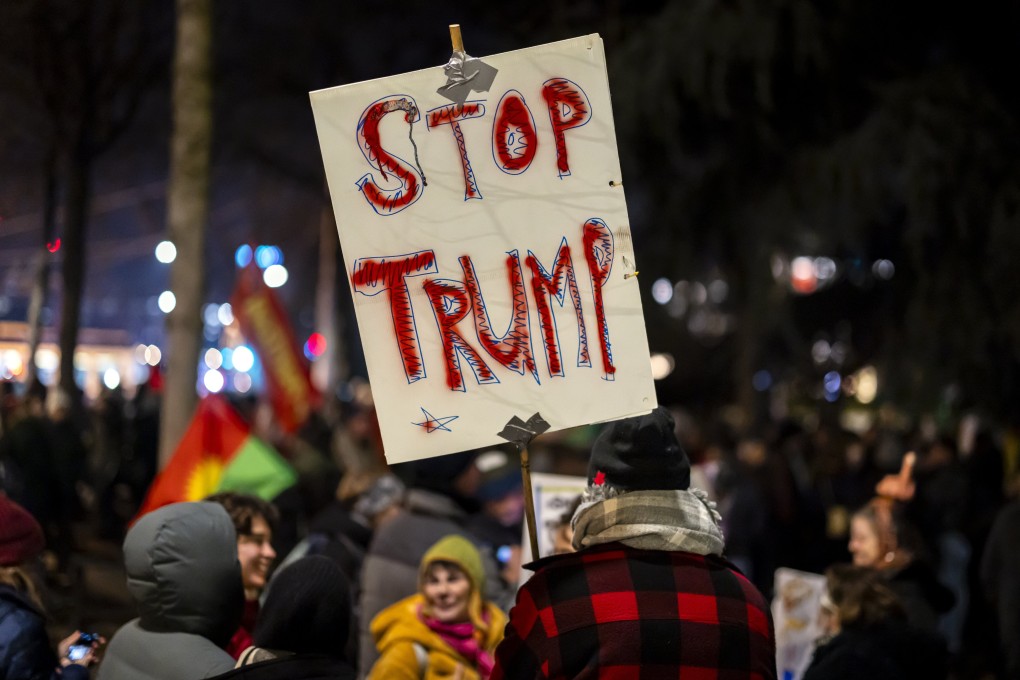 A protester holds a placard reading ‘Stop Trump’ during a rally in Zurich, Switzerland, on Monday, before the World Economic Forum meeting in Davos. Photo: EPA