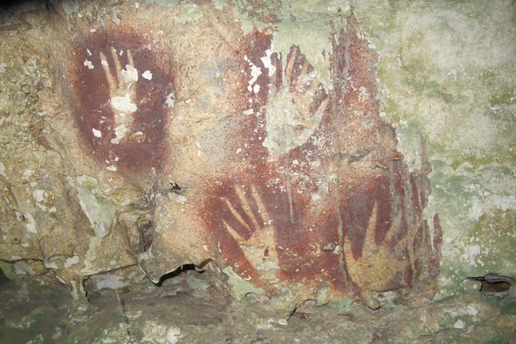 Handprints with sharpened fingertips are seen in the Maros region of Sulawesi, Indonesia. Photo: Ahdi Agus Oktaviana/Maxime Aubert via AP