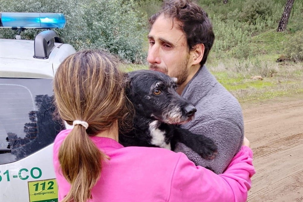 Ana Garcia hugs Boro on Thursday after the dog was rescued by Andalusia regional firefighters. Photo: Plan Infoca via Reuters