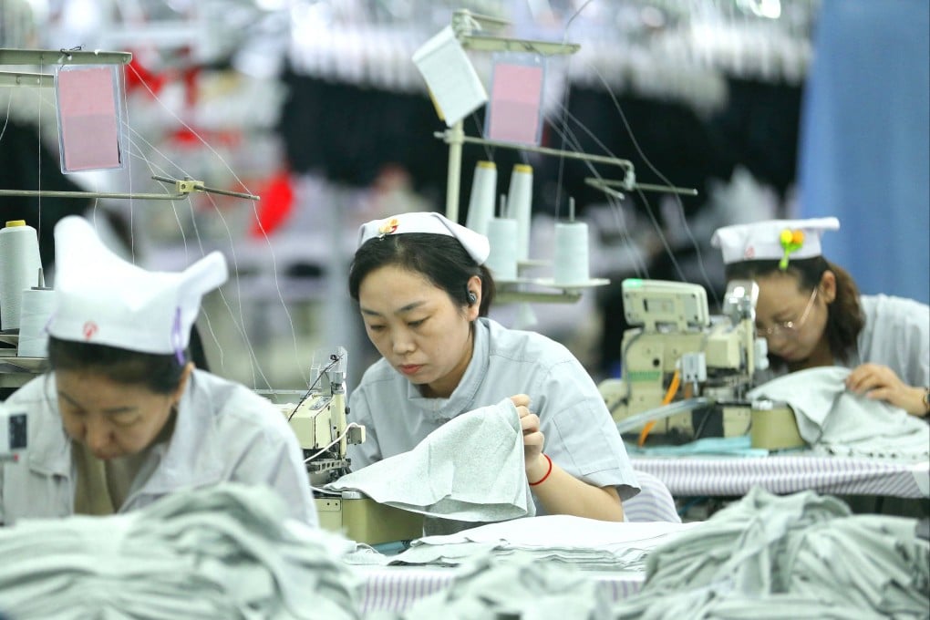 Workers sew garments at a textile factory in Qingdao, in eastern China’s Shandong province on December 15, 2025. As provinces raise the minimum wage, low-paid workers will see the most benefit. Photo: AFP