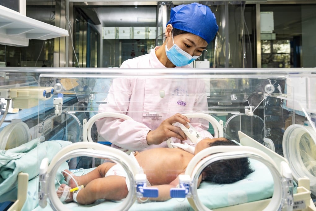 A nurse feeds a newborn at a hospital in Nanjing, China. The nation’s birthrate plunged by double digits last year. Photo: Getty Images