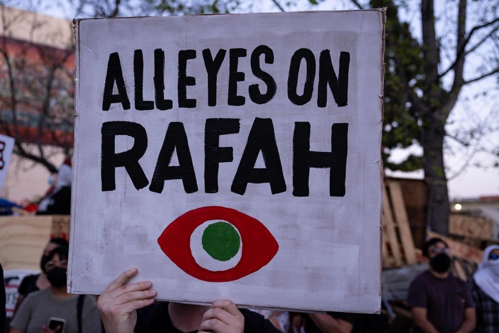 Demonstrators hold signs next to a pro-Palestinian encampment in Los Angeles in May 2024. Photo: AFP