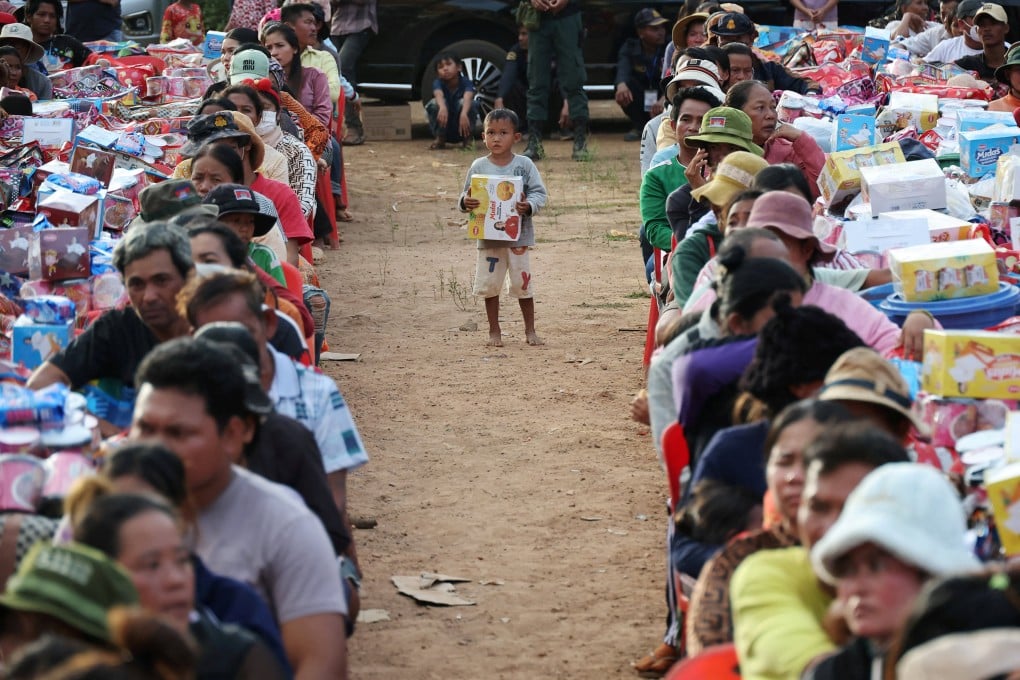 A boy stands among adults waiting to collect supplies at Batthkav refugee camp, amid clashes between Thailand and Cambodia, in Chong Kal, Oddar Meanchey province, Cambodia on December 12. Photo: Reuters