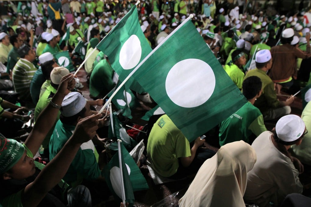 Supporters of the Pan-Malaysian Islamic Party (PAS) wave flags during a rally in Kedah in 2012. Photo: AFP