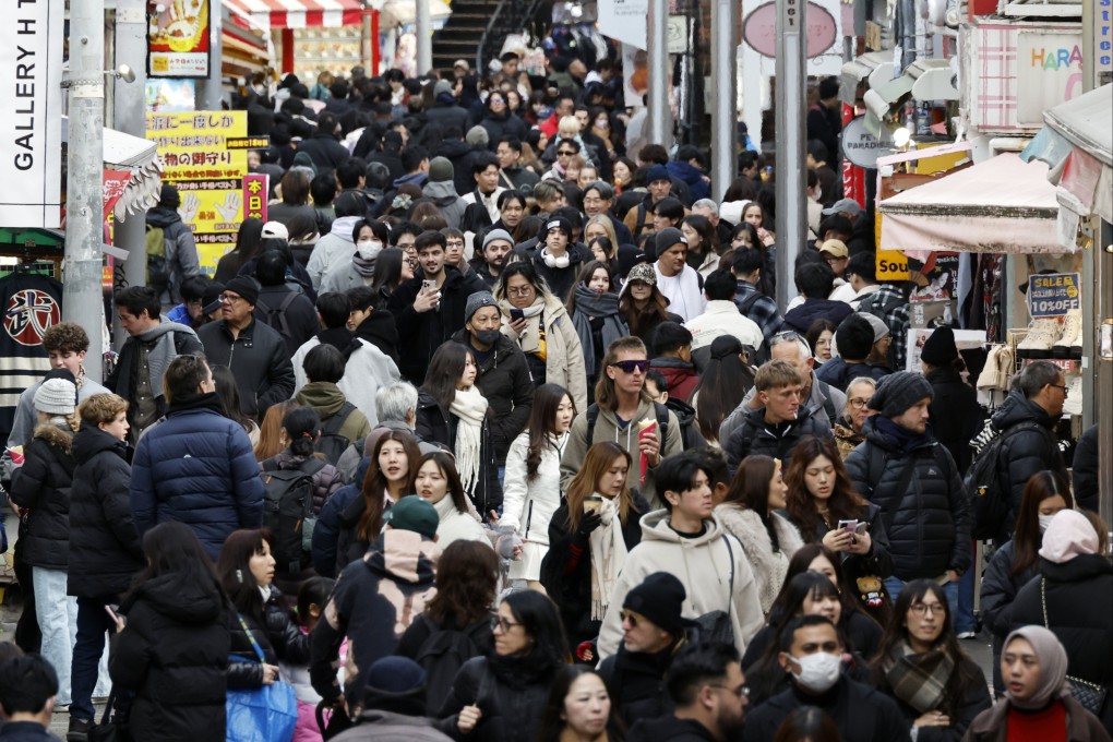 People walk along Takeshita Street, Harajuku, Tokyo. The number of tourist arrivals in Japan rose by 15.8 per cent to a record 42.7 million last year. Photo: EPA