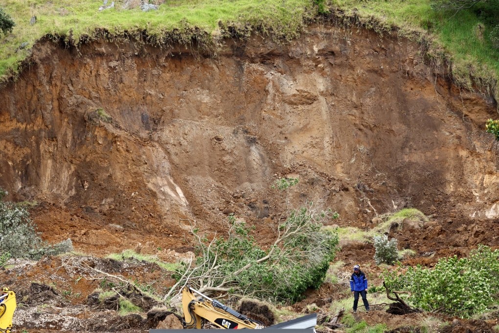 Rescuers work at the scene of a landslide in Mount Maunganui on Saturday . Photos: Reuters