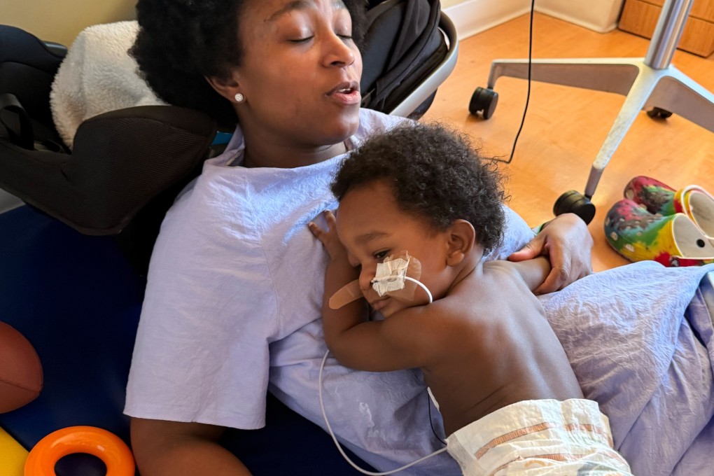 Ashaan Carter lies on his mother at a Portland children’s hospital during his treatment for infant botulism in November 2025 after drinking ByHeart baby formula donated to vulnerable families. Photo: AP