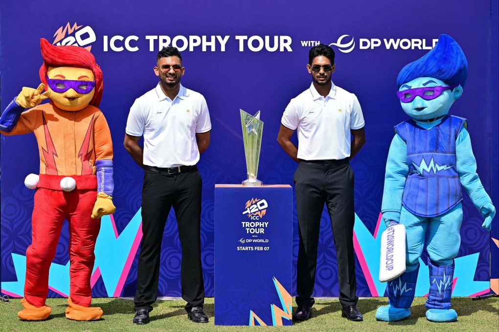 Sri Lank captain Dasun Shanaka (left) and teammate Matheesha Pathirana pose with mascots and the T20 Cricket World Cup trophy during an unveiling event at the Sinhalese Sports Club stadium in Colombo on Friday. Photo: AFP