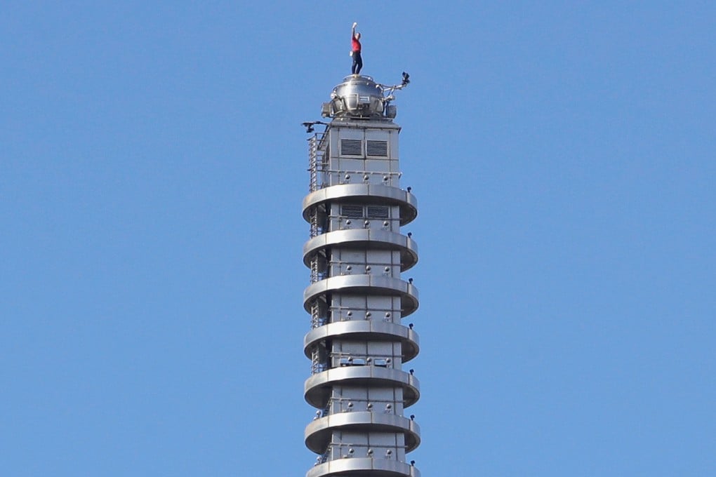 American rock climber Alex Honnold raises his fist after reaching the top of the Taipei 101 skyscraper on Sunday. Photo: AP