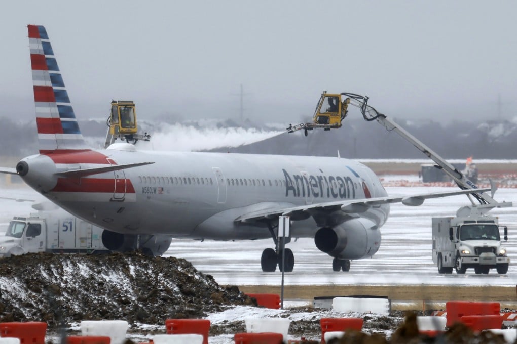 Ground crews de-ice an American Airlines jet at Dallas Fort Worth International Airport on Saturday. Photo: TNS