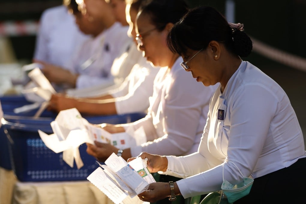 Myanmar electoral officials count ballots at a polling station in Yangon on Sunday. Photo: EPA