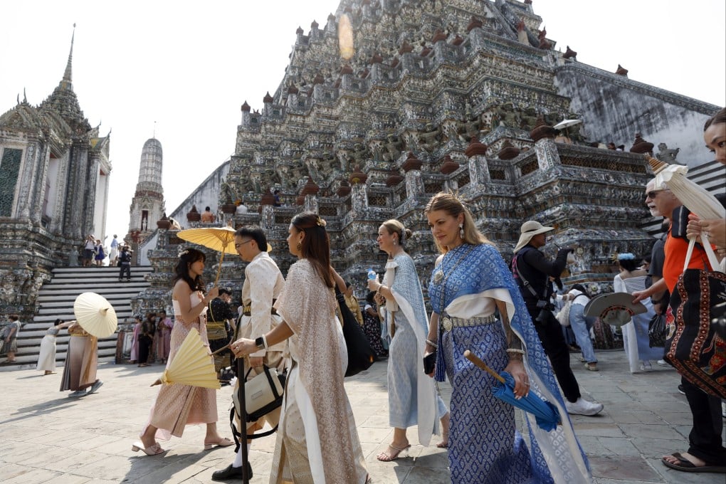Tourists dressed in traditional Thai attire visit the Temple of Dawn (Wat Arun) in Bangkok, Thailand, on January 19. Despite the multiple challenges it faced, the land of smiles still managed to welcome 33 million tourists last year. Photo: EPA