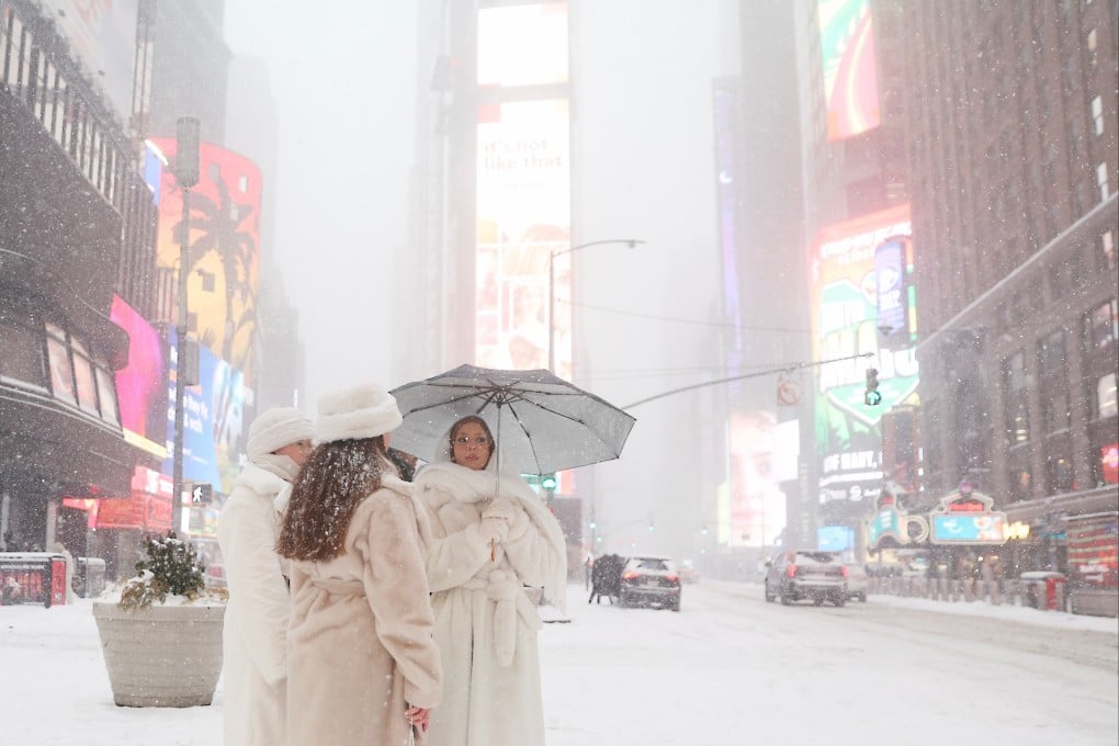 People wait to cross the street in Times Square, New York. Photo: AP