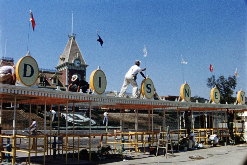 Workers construct the front gates of California’s Disneyland in a still from Disneyland Handcrafted, a new documentary on Disney+. Photo: TNS