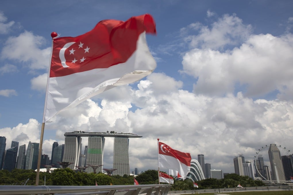 Singapore national flags flutter over a view of the city skyline in August 2022. Photo: EPA-EFE