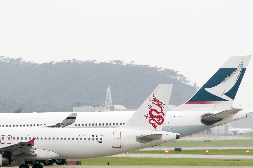 A Dragonair plane sits besides a Cathay Pacific plane on Hong Kong’s Chek Lap Kok airport tarmac on June 7, 2006. Photo: SCMP