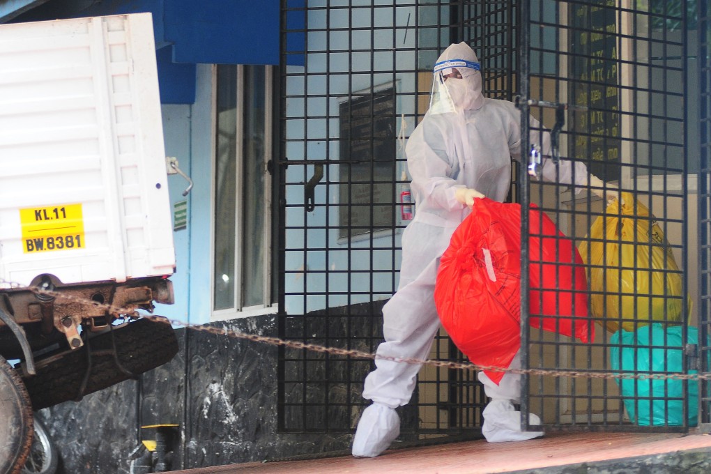 A health worker removes biohazardous waste from a Nipah virus isolation centre during an outbreak in India in 2023. Photo: AFP