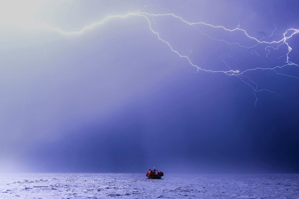 Crew members of the ‘Ocean Viking’ ship take part in a night rescue exercise in the Mediterranean Sea. Photo: AFP