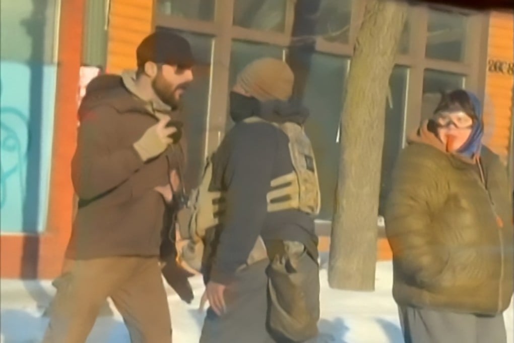 This screengrab of video footage shot by @dangjessie shows Alex Pretti (left) and a federal immigration agent (centre) before Pretti was shot dead in Minneapolis, Minnesota, on Saturday. Photo: @dangjessie/UGC/AFP
