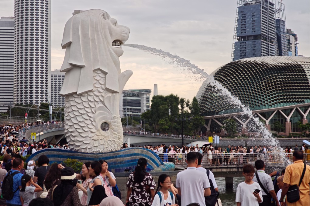 People gathering at the Merlion Park in Singapore. Photo: Wang Gang/Future Publishing via Getty Images