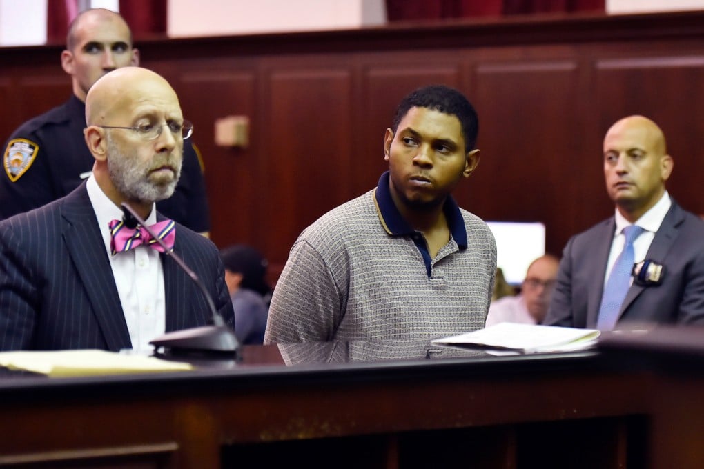 Randy Santos (centre) is arraigned in New York in October 2019 for the murder of four homeless men. Photo: New York Post via AP