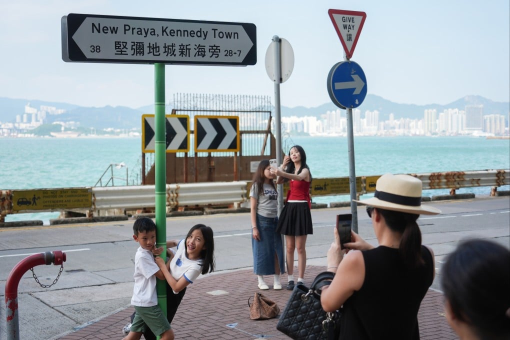 Mainland tourists take pictures in Kennedy Town. Photo: Eugene Lee