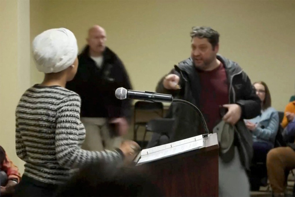 A man shouts at congresswoman Ilhan Omar after spraying her. Photo: Reuters