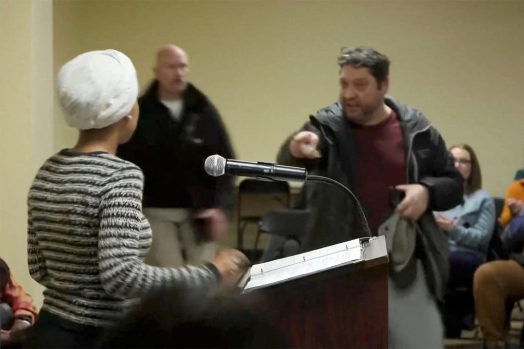 A man shouts at congresswoman Ilhan Omar after spraying her. Photo: Reuters