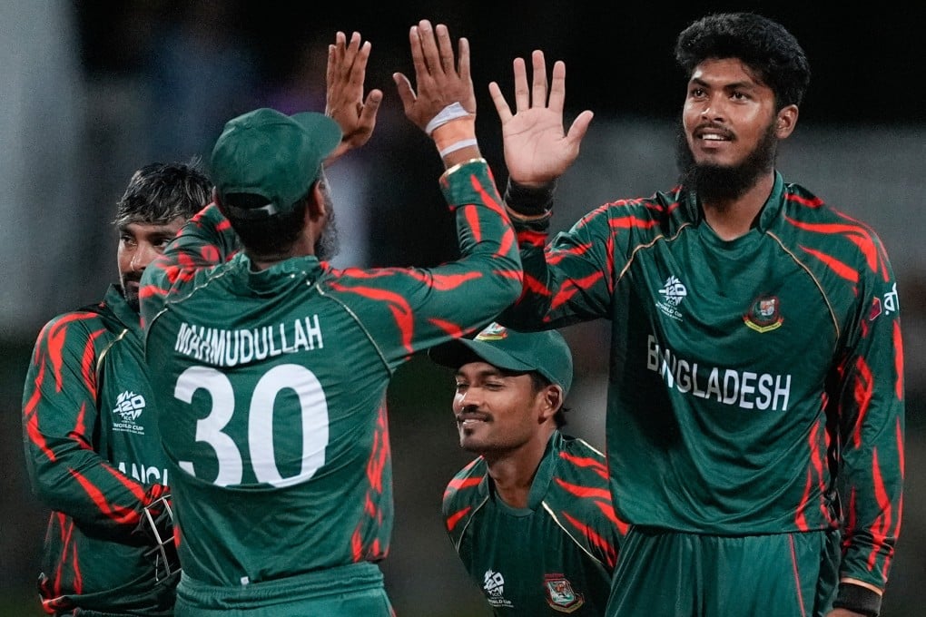 Bangladesh’s Rishad Hossain (right) is congratulated by teammate Mahmudullah during a T20 World Cup cricket match on June 20, 2024. Photo: AP