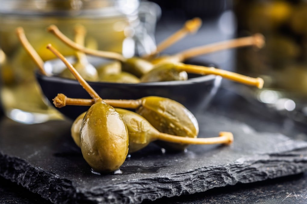Both capers and caper berries (pictured) can supercharge simple recipes, from pastas to salads and sauces. Photo: Shutterstock