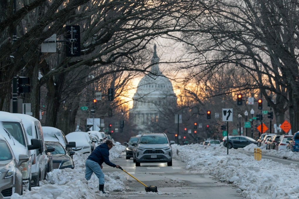 A man shovels snow into a street in Washington near the US Capitol. Photo: Reuters
