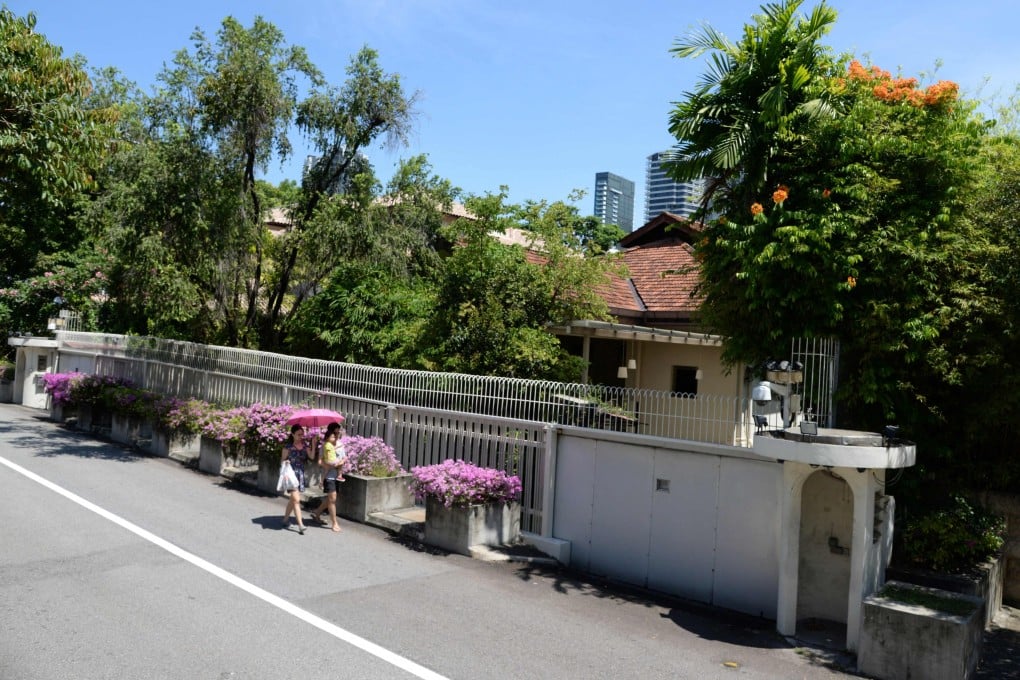 Residents walk past the house of Singapore’s founding prime minister Lee Kuan Yew at 38 Oxley Road in the city state. Photo: AFP