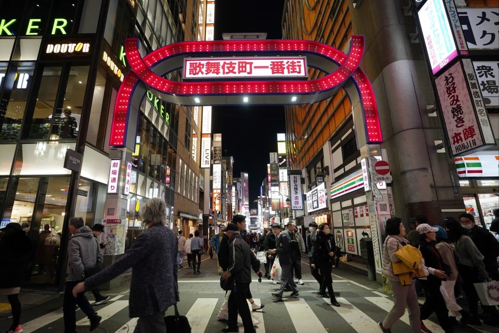 Pedestrians walk past an entrance at Kabukicho, Shinjuku, Tokyo. Natural, a leading tokuryu criminal group, started its operations in the nightlife district in 2019. Photo: EPA-EFE